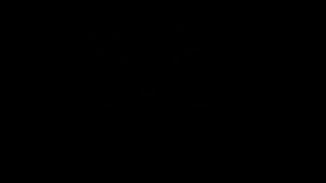 A person gently stretching their neck to one side while sitting at a desk