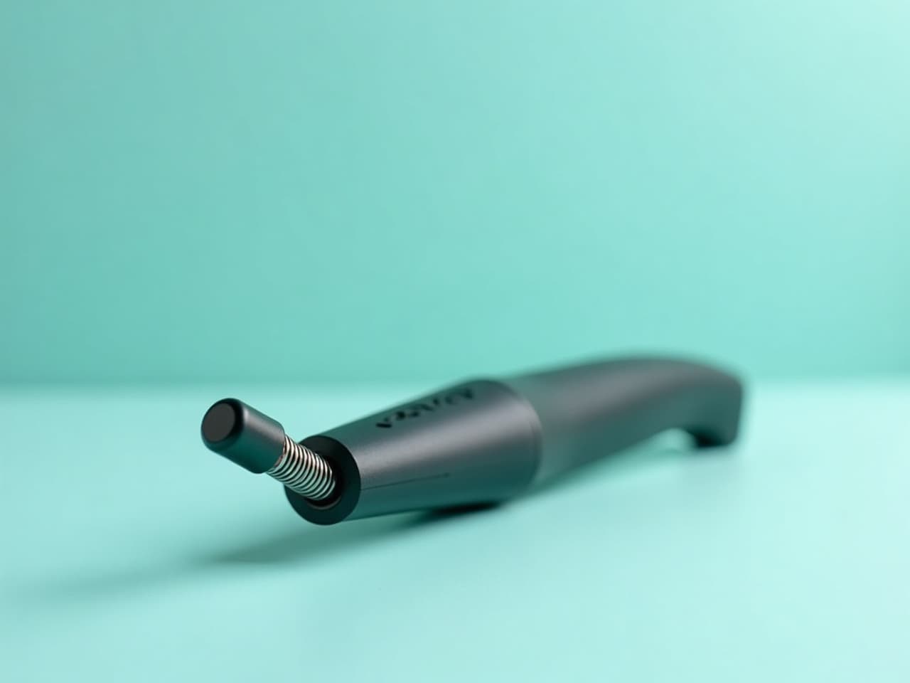 A small handheld spring loaded chiropractic adjusting instrument held by a clinician